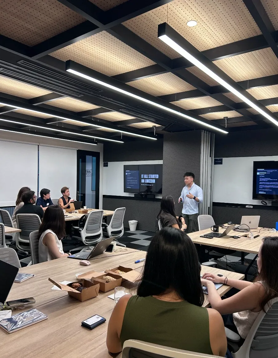 Eugene Cheng speaking to senior leaders at a workshop hosted by LinkedIn Singapore, with “It all started on LinkedIn” on the screen