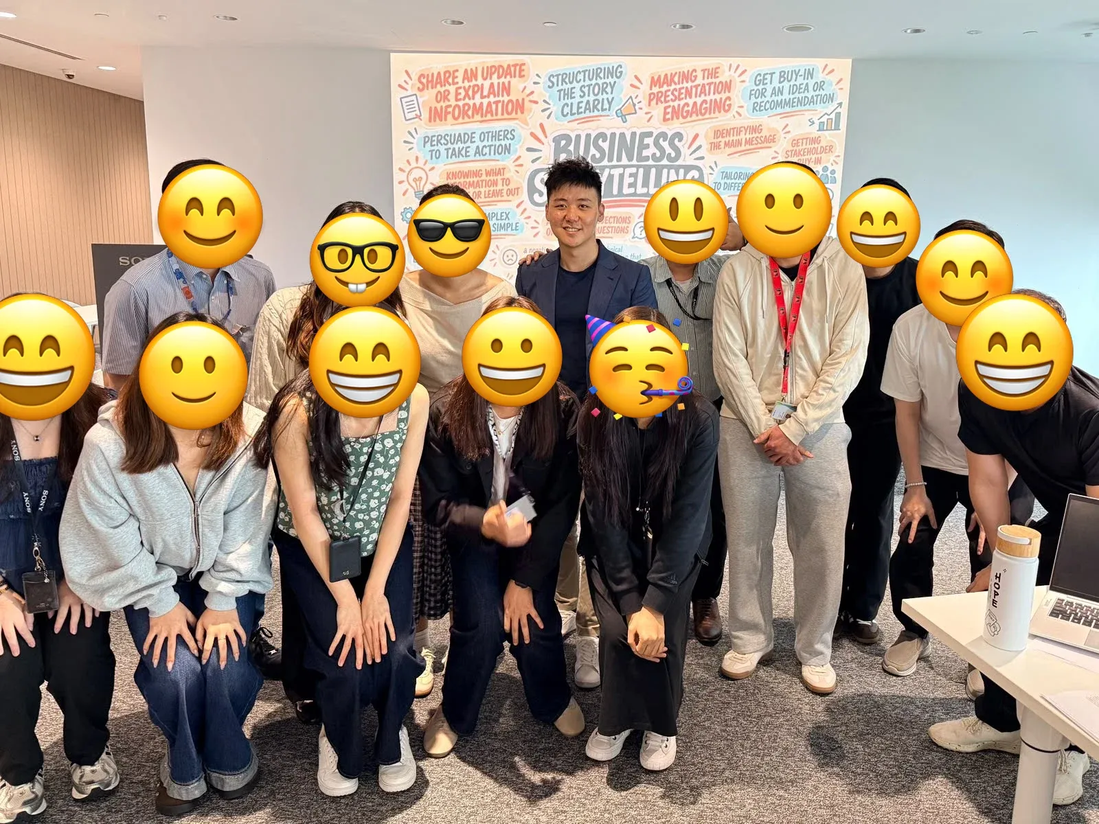 Eugene Cheng with a Sony team after a Business Storytelling training session, in front of a hand-drawn storytelling wall