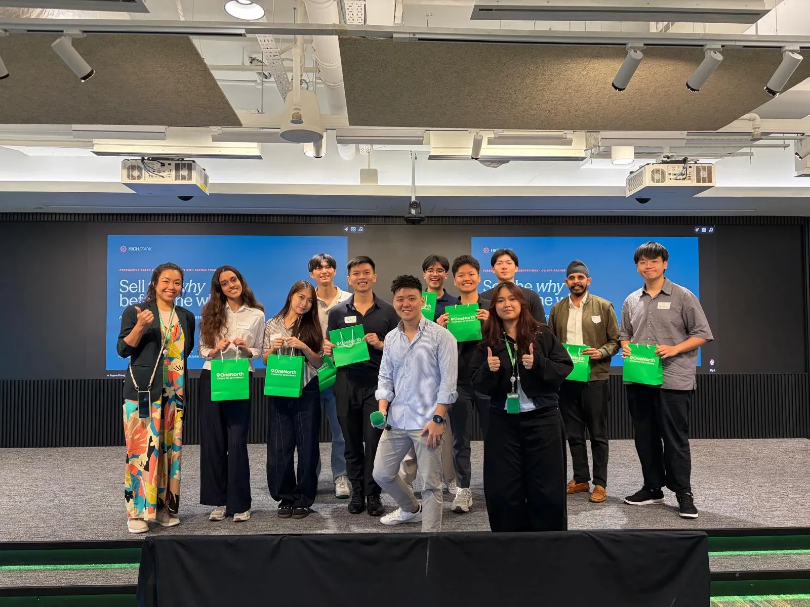 Eugene Cheng on stage with the cohort of a Grab campus programme workshop on persuasive sales presentations
