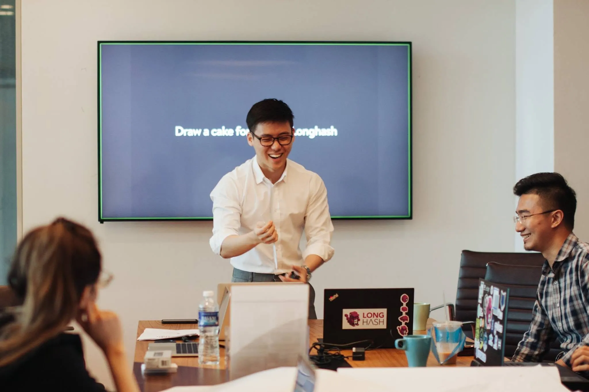 Eugene Cheng leading a startup workshop at LongHash, laughing mid-exercise