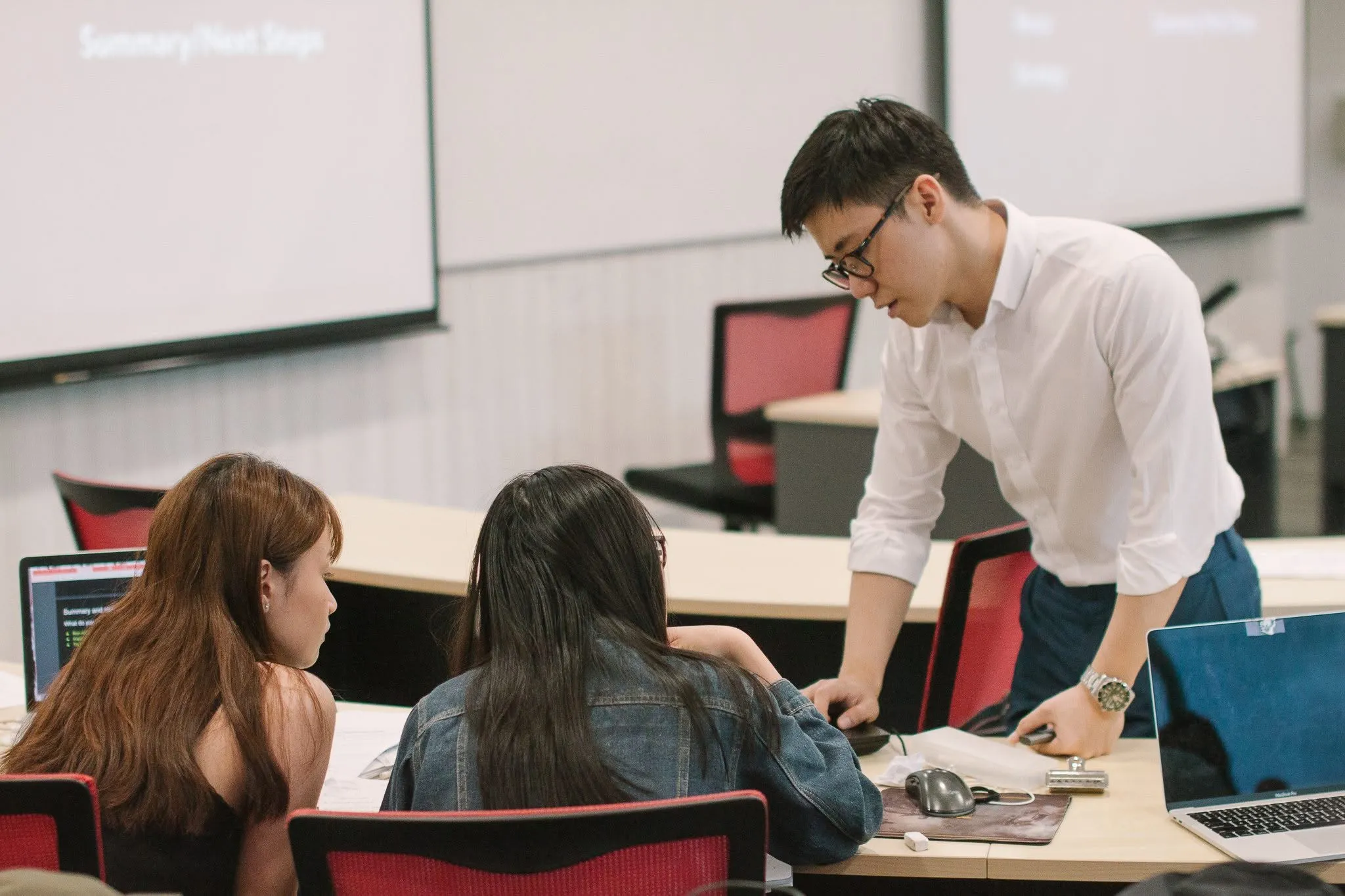 Eugene Cheng coaching two participants through an exercise at a Startup Talent Factory workshop